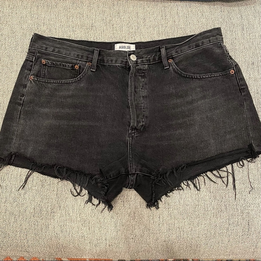 Agolde cutoff denim shorts in washed black.